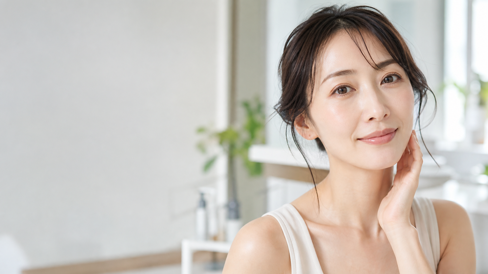 朝の洗面台で肌の印象を確認する日本人女性